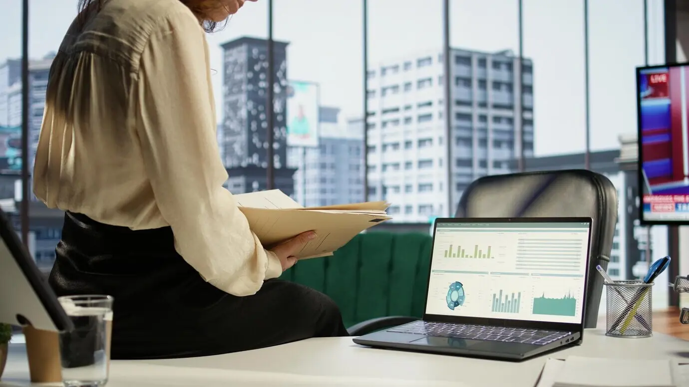 Амбициозная женщина‑генеральный директор работает в своем современном корпоративном офисе.